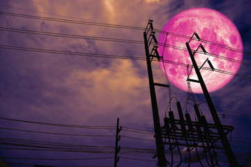 full pink moon back silhouette power electric line pillar in dark night sky