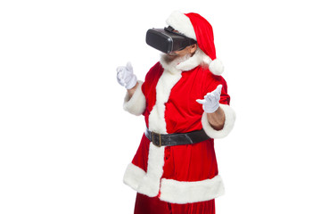 Christmas. Santa Claus in black virtual reality glasses makes gestures with his hands. Surprise, emotion. New technology. Isolated on white background.