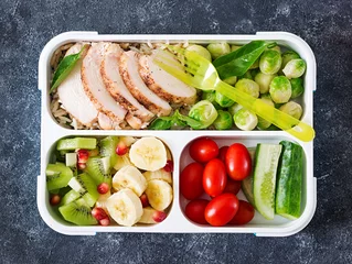 Gordijnen Healthy green meal prep containers with chicken fillet, rice, brussels sprouts, vegetables and fruits overhead shot with copy space. Dinner in lunch box. Top view. Flat lay © timolina