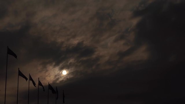 Flags waving in front of rising sun