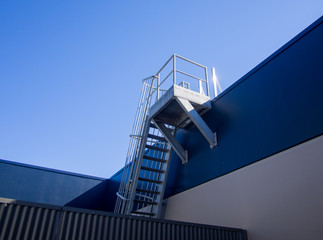 Steel cage fire ladder to the roof top of the building