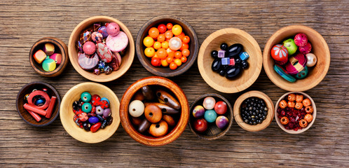 Colorful beads in wooden bowls