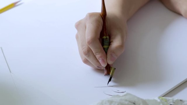 Calligrapher writing a letter.