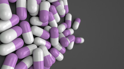 Obraz na płótnie Canvas Pile of white and purple medicine capsules