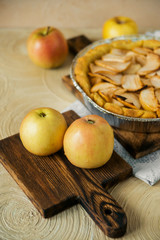 Naklejka na ściany i meble Traditional home-made autumn Apple pie-Charlotte, on a light background with appliances.