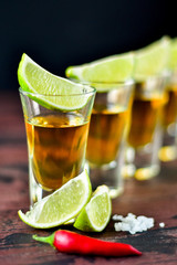 Red chili on a glass of alcohol, five glasses of alcohol and lime, a party at the bar, a menu for the bar. Selective focus and copy space