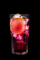 A purple, pink transparent cocktail, refreshing in a tall glass with ice cubes and lemon slice. Side view Isolated black background. Drink for the menu