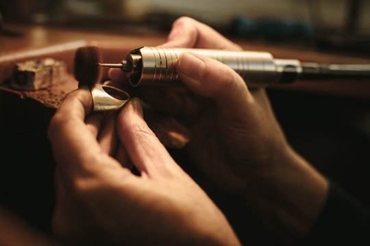 Jeweler making gold ring