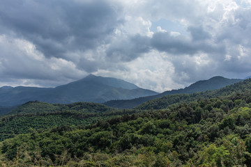 Storm cloudscape on a green mountain landscape