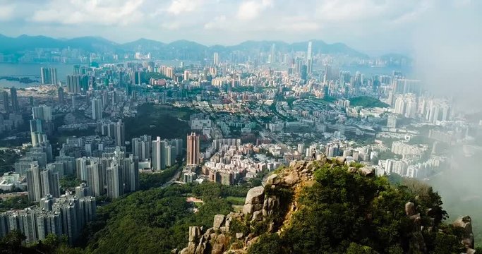 Man taking photo of Hong Kong cityscape from the Lion rock aerial view