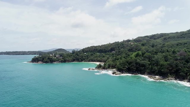 Tropical sea with wave crashing on beach aerial view drone shot