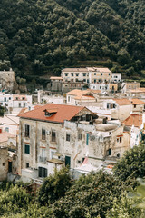 Fototapeta na wymiar The Amalfi coast and the mountain slopes with plantations of lemons. Panoramic view of the city and nature of Italy. Evening landscapes and winding roads