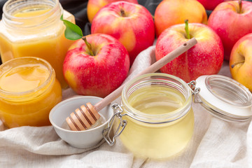 Jewish holiday Rosh Hashanah background with honey and apples on wooden table.