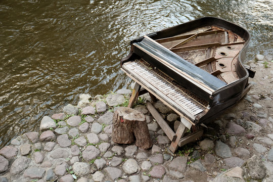 Old grand piano on river side