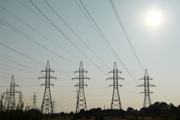 Electricity transmission pylons in sunset