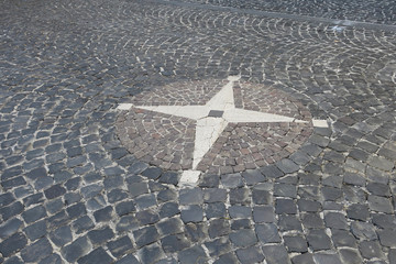 compass on the pavement of a road in Gradoli Italy