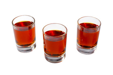 Red transparent cocktails, a set of shots pile, wedge, three servings, with taste of berries, cherries, strawberries, greiprut, cola. Side view from above Isolated white background