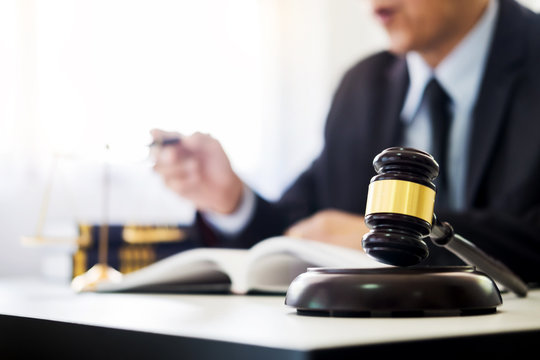 gavel and soundblock of justice law and lawyer working on wooden desk background.