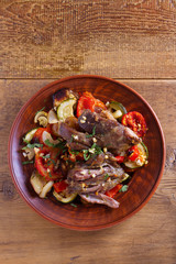 Slow cooker lamb with vegetables and garlic. View from above, top studio shot