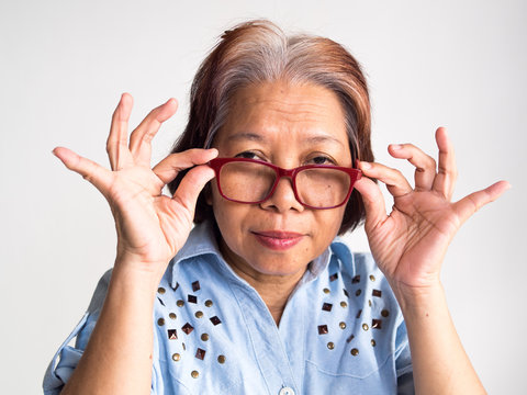 Senior Retirement Elderly Old Southeast Asia Asian Women Hold A Eyeglasses Look At Camera With Confused Emotions Can Use In Healthy Insurance Retire People Medical Coaching Financial Planning Concept