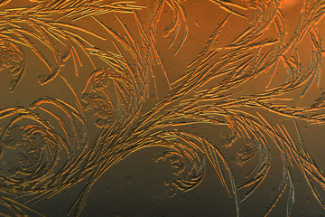 Gold frost drawings on the glass as a background