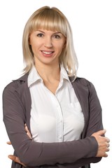 Professionally dressed woman wearing glasses with her arms