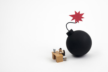 miniature man working with bomb ready to explode