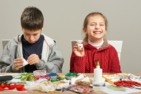 Childrens making decorations for new year holiday. Painting watercolors. Top view. Artwork workplace with creative accessories.