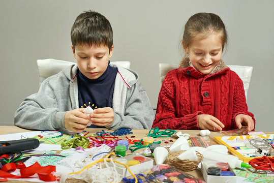 Childrens making decorations for new year holiday. Painting watercolors. Top view. Artwork workplace with creative accessories.