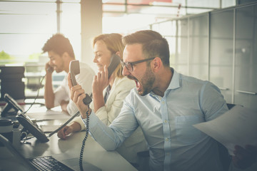 People in operations center  talking on Landline phone.