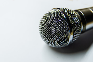 Silver audio microphone on white background