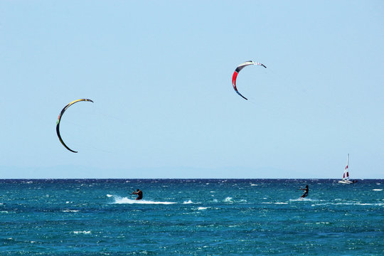Torre Mozza (Ugento), Lecce, Italy - August 15, 2016 - Day at the seaside, with sports and entertainment (kite surfing, wind surfing and yatch), in August in Salento