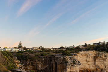 Fototapeta na wymiar Residential suburb along the cliff coastline with morning cloudy sky.
