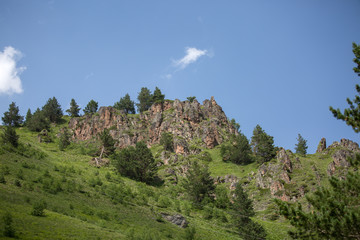 Fototapeta na wymiar Photo of mountain slopes with vegetation and cloudy sky