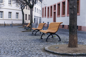 Iron benches with wooden seats in the square in the German city of Mainz