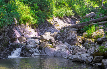 Naklejka na ściany i meble mountain river. water motion near the stones