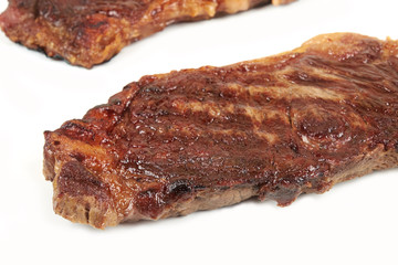 Grilled beef steak isolated over white background.