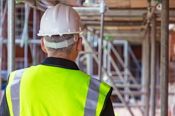 Rear View of a Construction Worker on Building Site