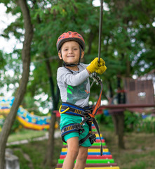 Boy at climbing activity in high wire forest park. Table Mountain Cableway kids special on again.