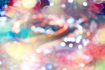 blurred bokeh city background / glare and glowing light in night city, modern beautiful bright...