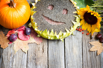Harvest Thanksgiving autumn fall background with happy sunflower  fruits and vegetables
