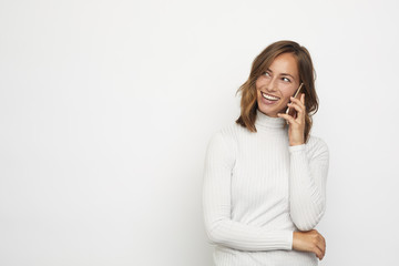 portrait of young beautyful woman on the phone looks left at copy space