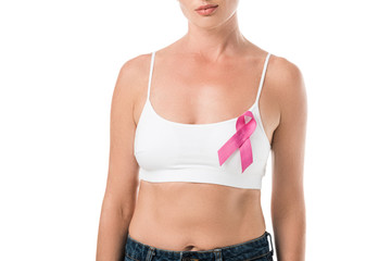 cropped shot of woman in underwear with pink ribbon standing isolated on white, breast cancer...