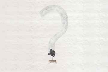 Janitor cleans the snowy yard and draws by shovel question mark on the snow. Concept