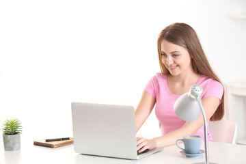 Female freelancer working on laptop in home office