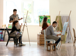Group of people during classes in school of painters