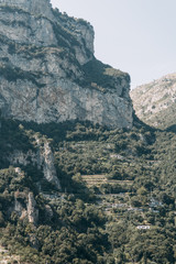 The coast of Positano, Amalfi in Italy. Panorama of the evening city and the streets with shops and cafes. Houses by the sea and the beach. Ancient architecture and temples