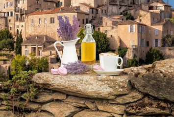 Lavender still life with cup of coffee against Gordes village in Provence, France