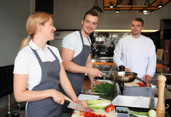 Chef and group of young people during cooking classes