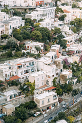 Fototapeta na wymiar The coast of Positano, Amalfi in Italy. Panorama of the evening city and the streets with shops and cafes. Houses by the sea and the beach. Ancient architecture and temples
